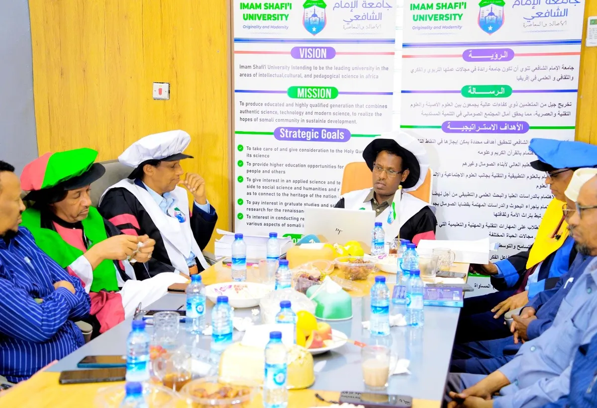 University leadership in academic regalia meeting around a boardroom table