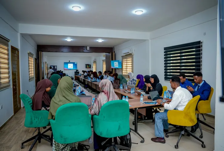 Participants learning together around a table during a training session