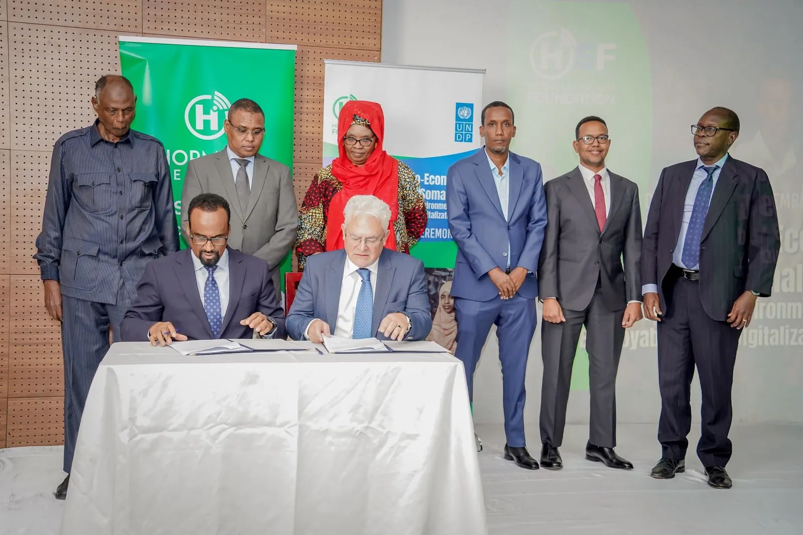 Officials signing an agreement at a formal ceremony in Somalia