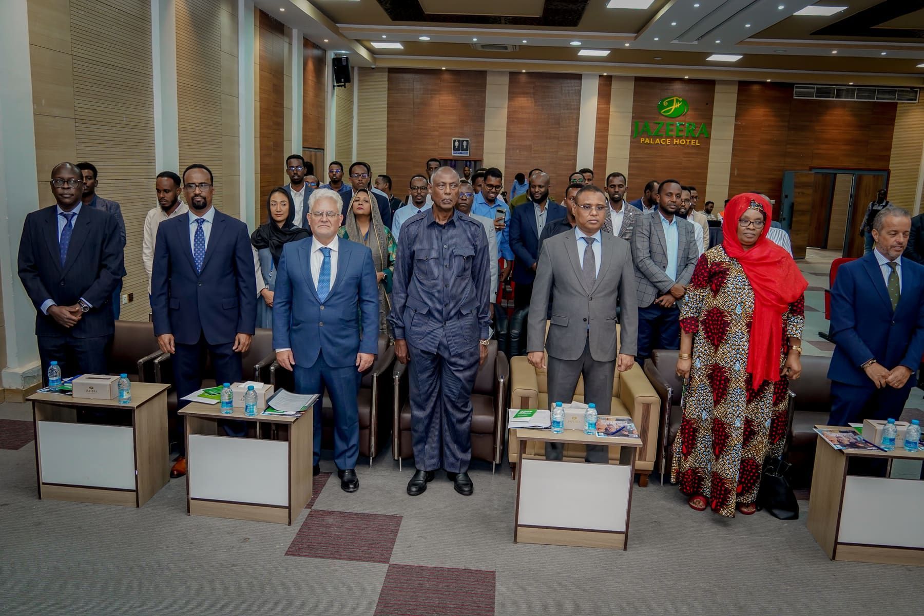 Officials and delegates standing together at a formal institutional event in Somalia