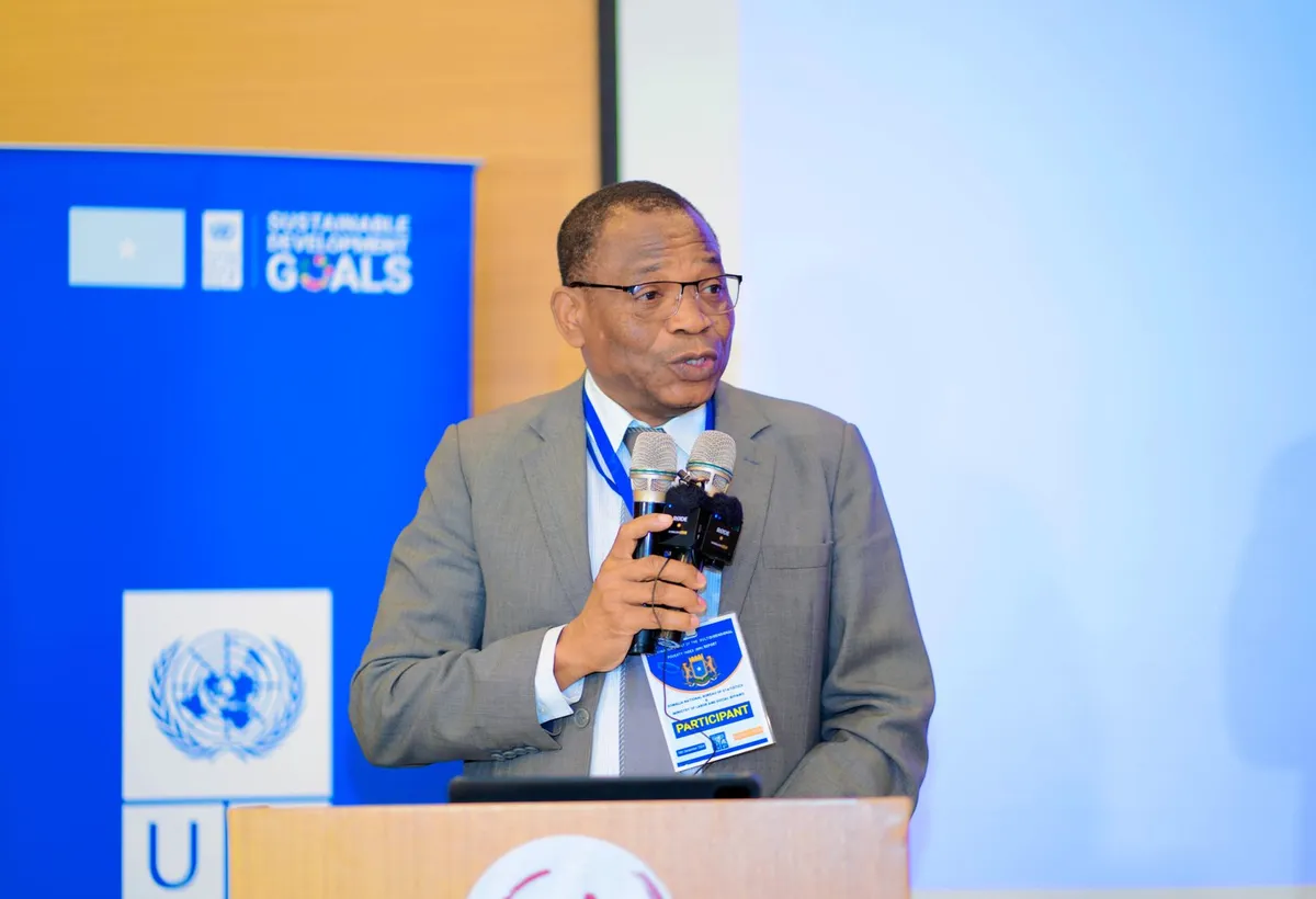 A speaker addressing delegates from a podium at a government and development-partner forum