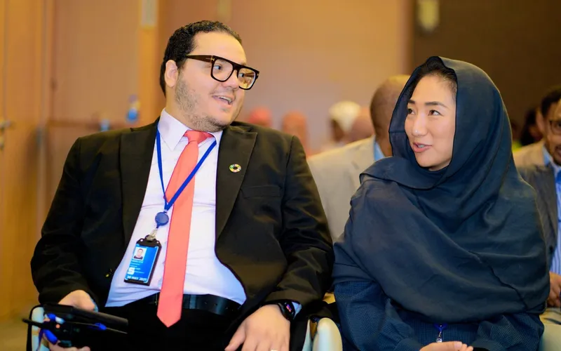 Two delegates discussing material at a data-validation workshop